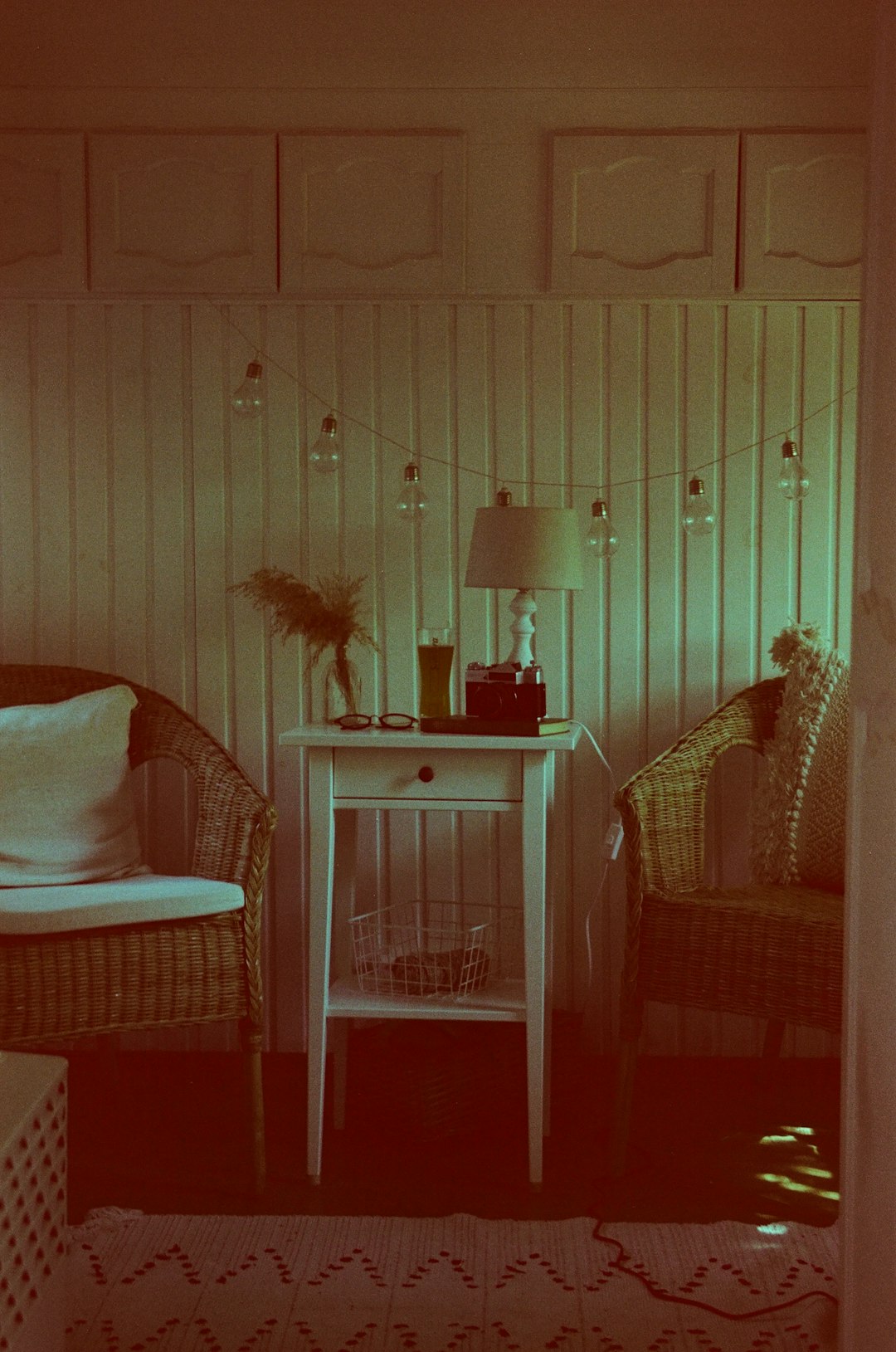 white and brown wooden armchair beside black table lamp