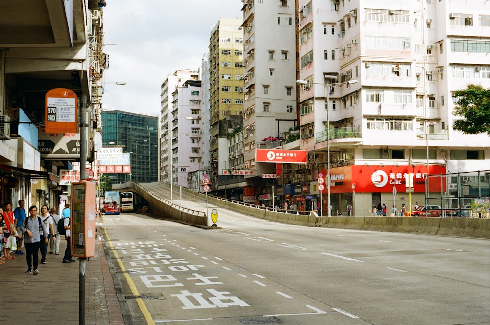 white and red concrete building beside gray concrete road during daytime