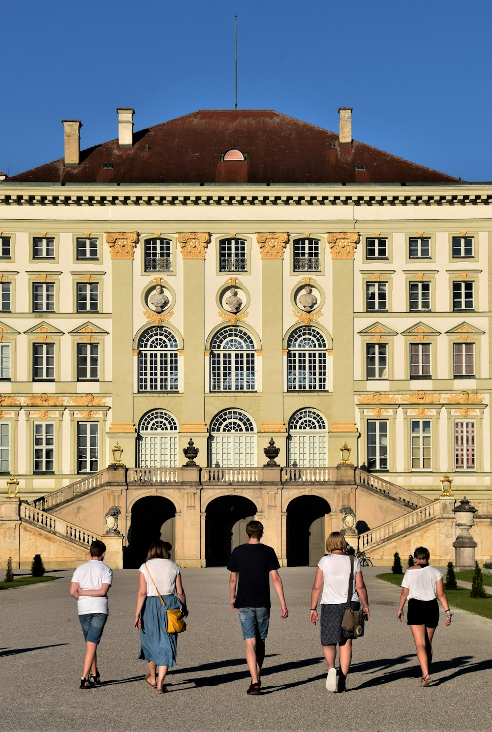 people in front of beige concrete building during daytime