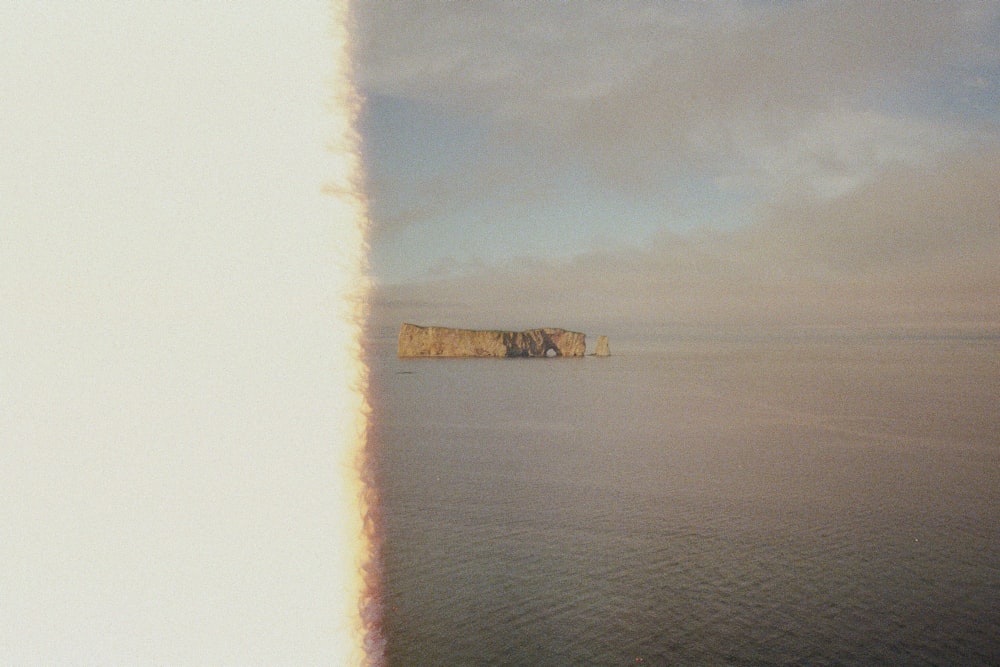 brown concrete building on body of water under white clouds during daytime