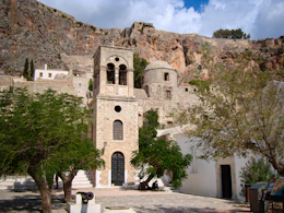 white concrete building near green trees during daytime