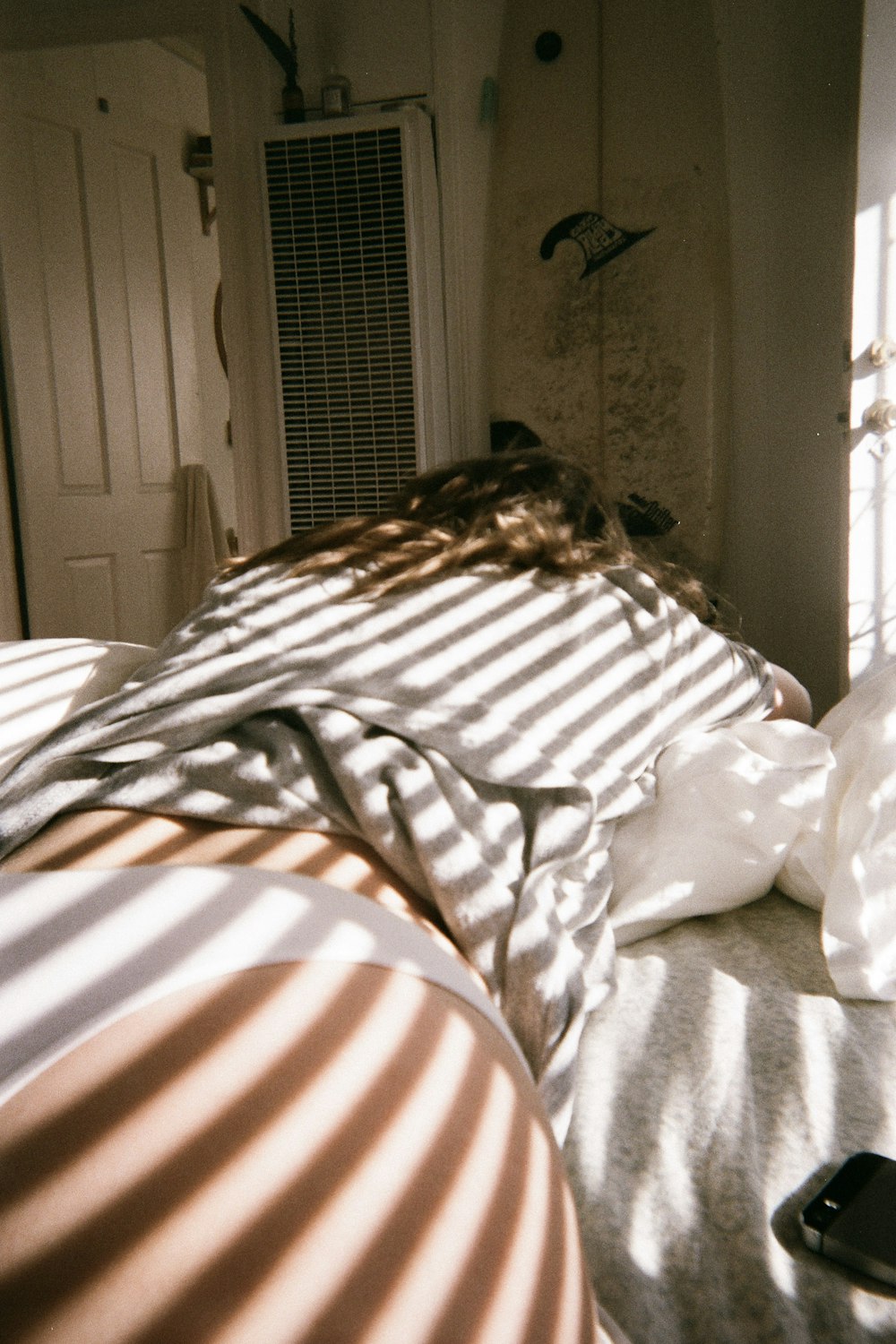 person in white and brown shirt lying on bed