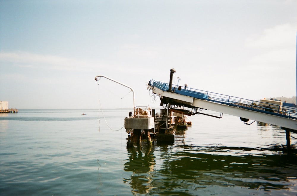 white and blue ship on sea during daytime