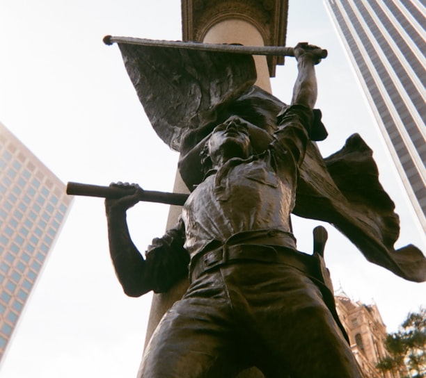 man holding a sword statue