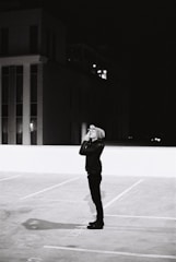 Detective conducting a stakeout at night with binoculars.