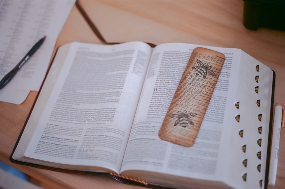 white book page on brown wooden table