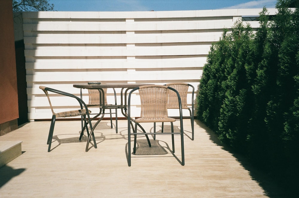 Mesa y sillas de madera blanca con marco de metal negro