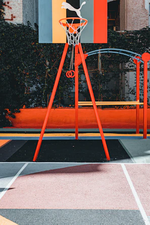 A vibrant basketball court painted with bold, artistic designs under a clear blue sky.