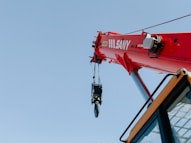 red and black helicopter flying during daytime