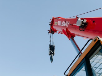 red and black helicopter flying during daytime