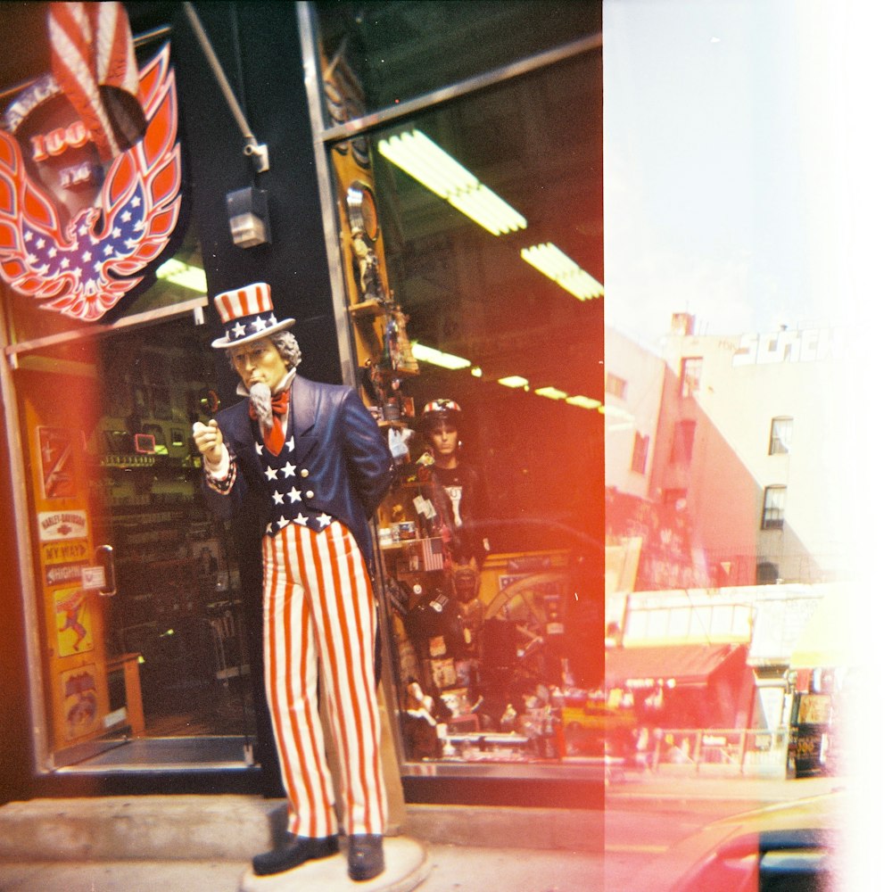 man in black and white striped long sleeve dress standing near glass window