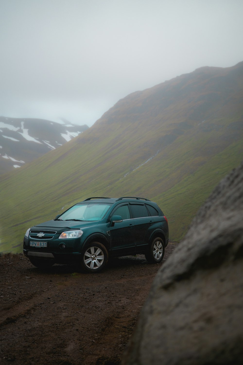 black suv on gray rocky mountain during daytime