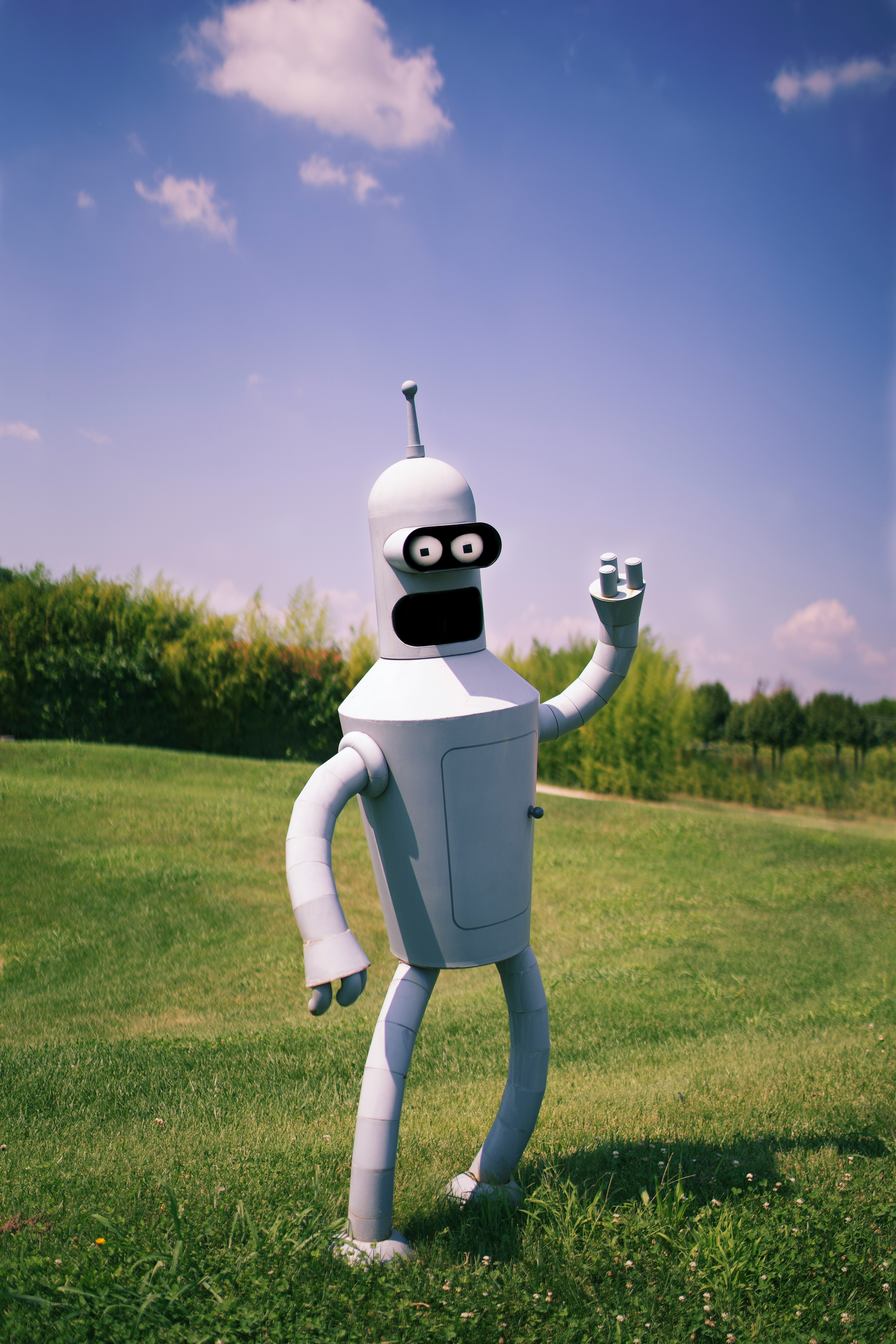 white robot on green grass field during daytime