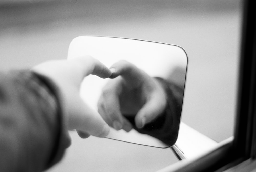 persons hand on white surface