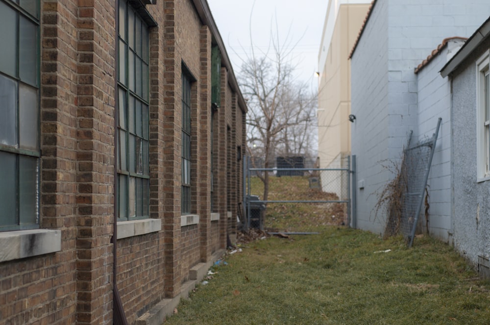 brown brick building with green grass lawn