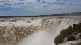 waterfalls under blue sky during daytime