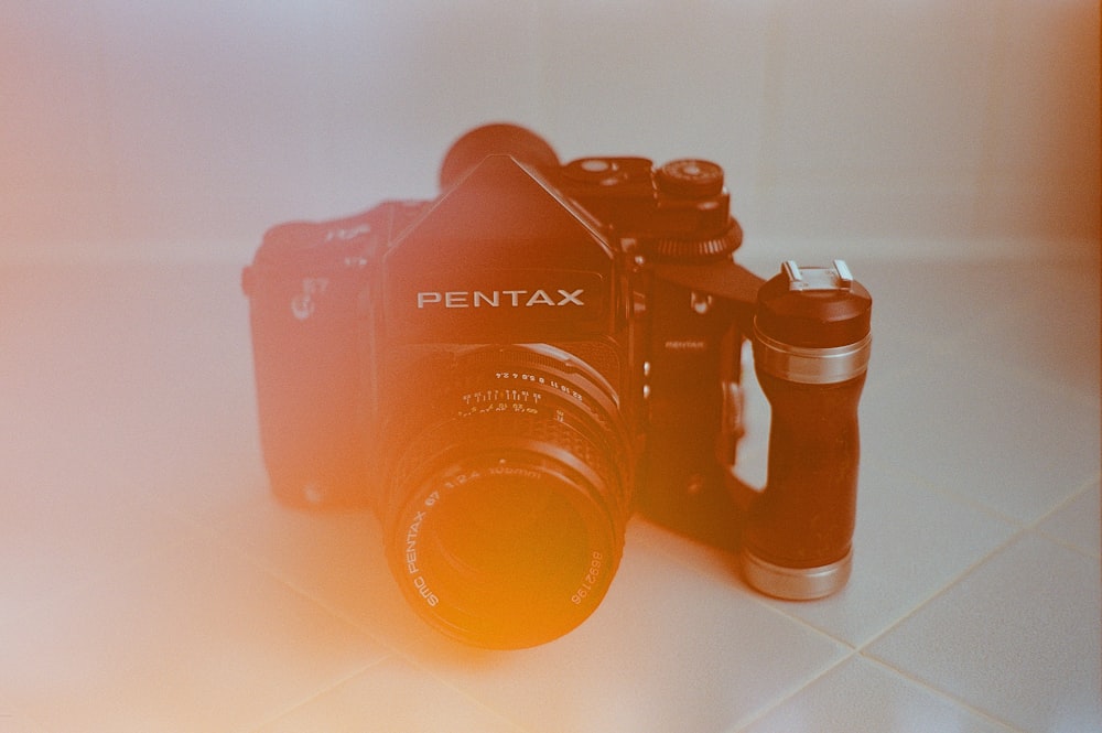 black nikon dslr camera on white table