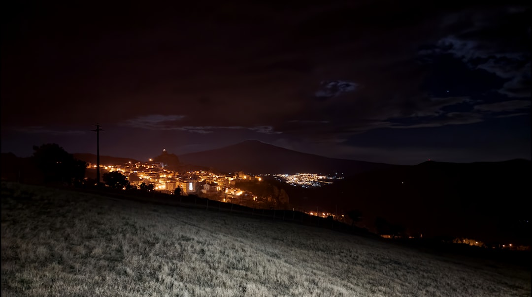 city lights on snow covered ground during night time