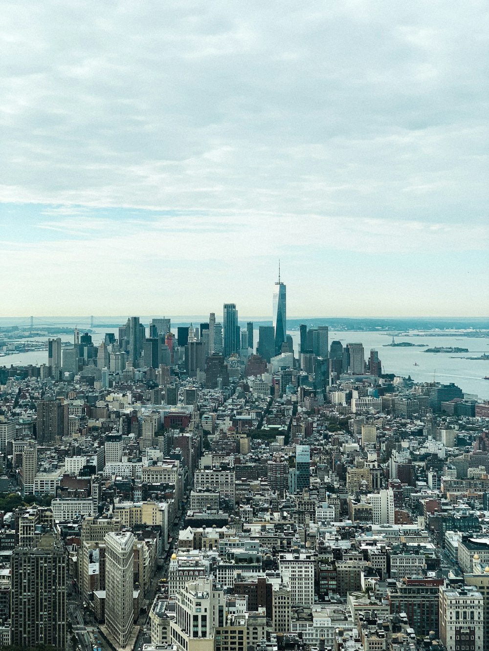 city skyline under white clouds during daytime