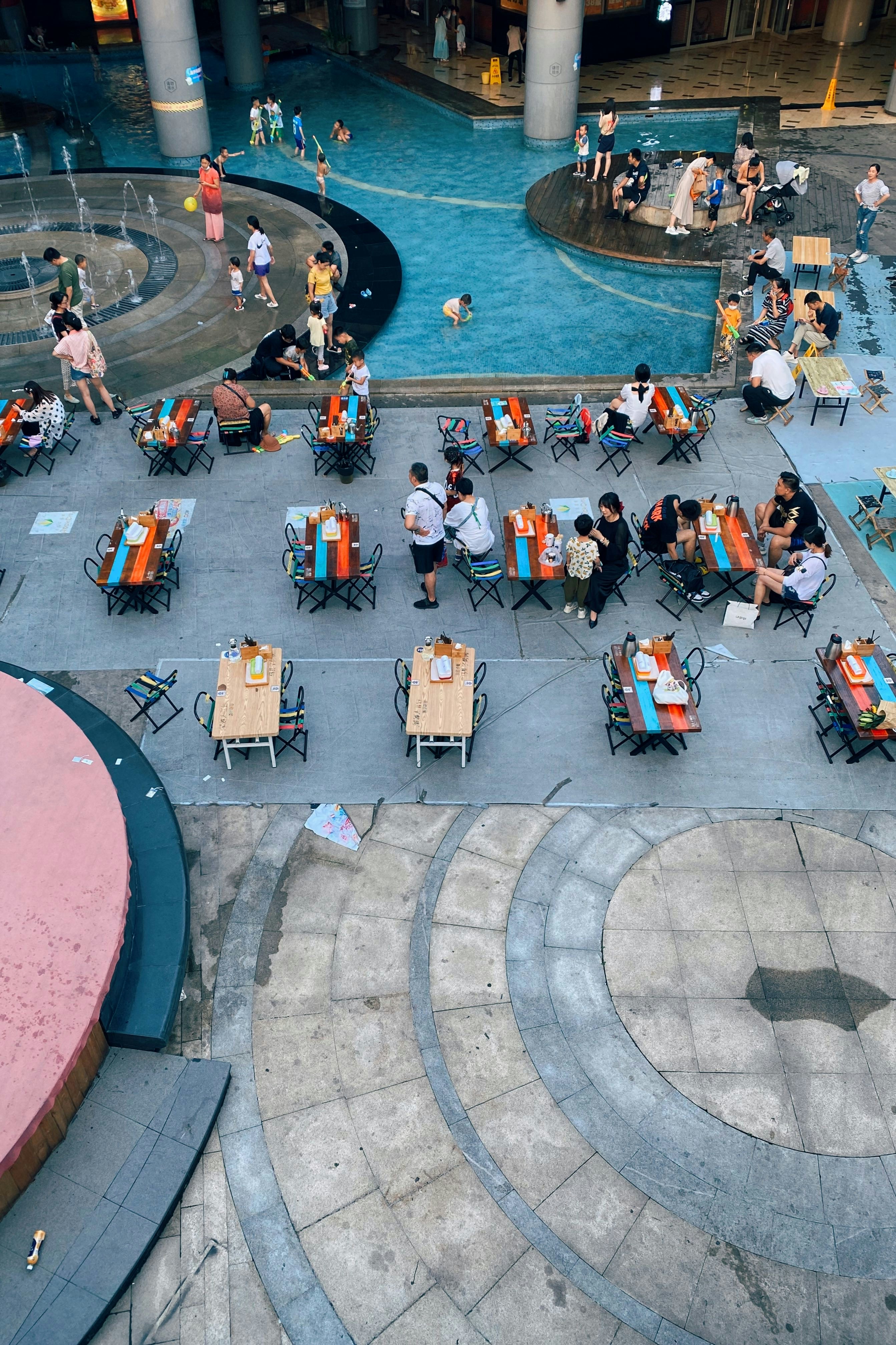 People enjoying a meal on an outdoor patio with cityscape in the background