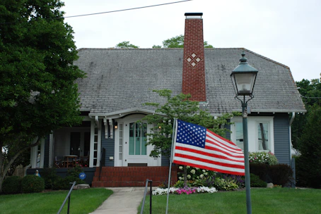 Cozy Burnley home exterior with welcoming front porch on a sunny day.