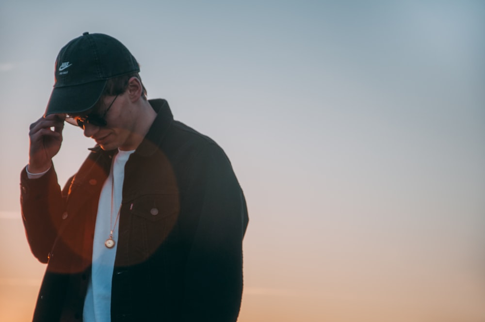 man in black jacket wearing black sunglasses