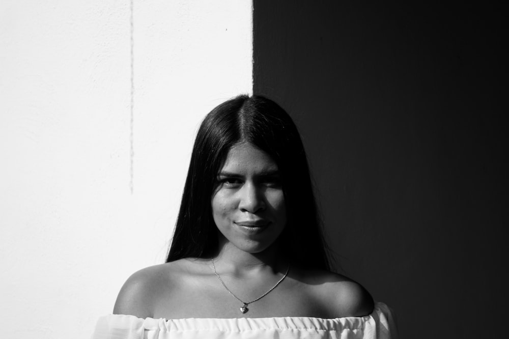 woman in white shirt wearing silver necklace