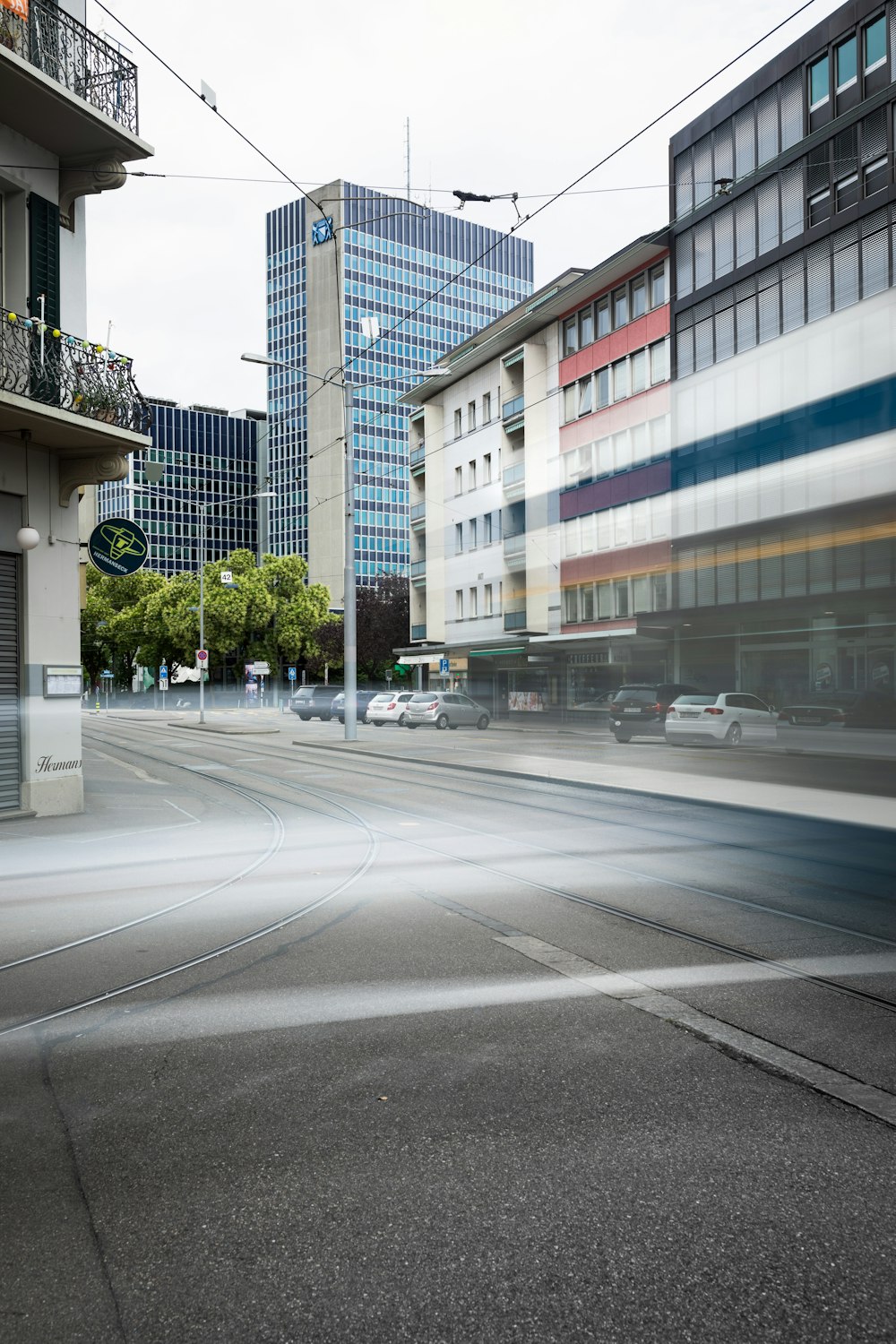 white and blue building beside gray asphalt road during daytime