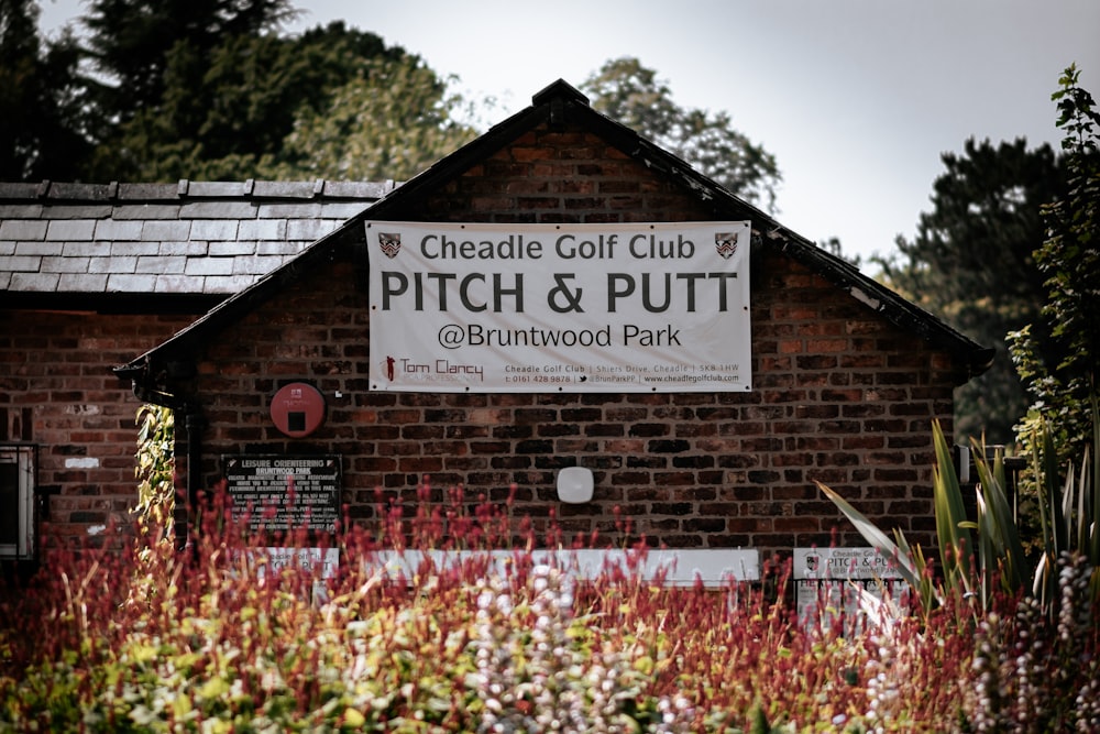 red and white flowers near brown wooden signage