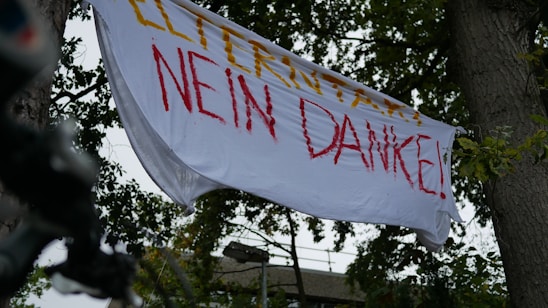A medieval-style banner displaying logos of festival sponsors with ornate borders and rustic textures.