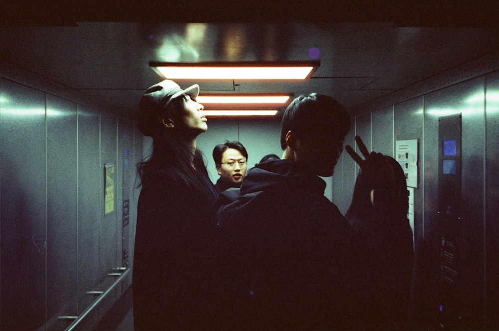 man in black hoodie standing beside woman in black jacket