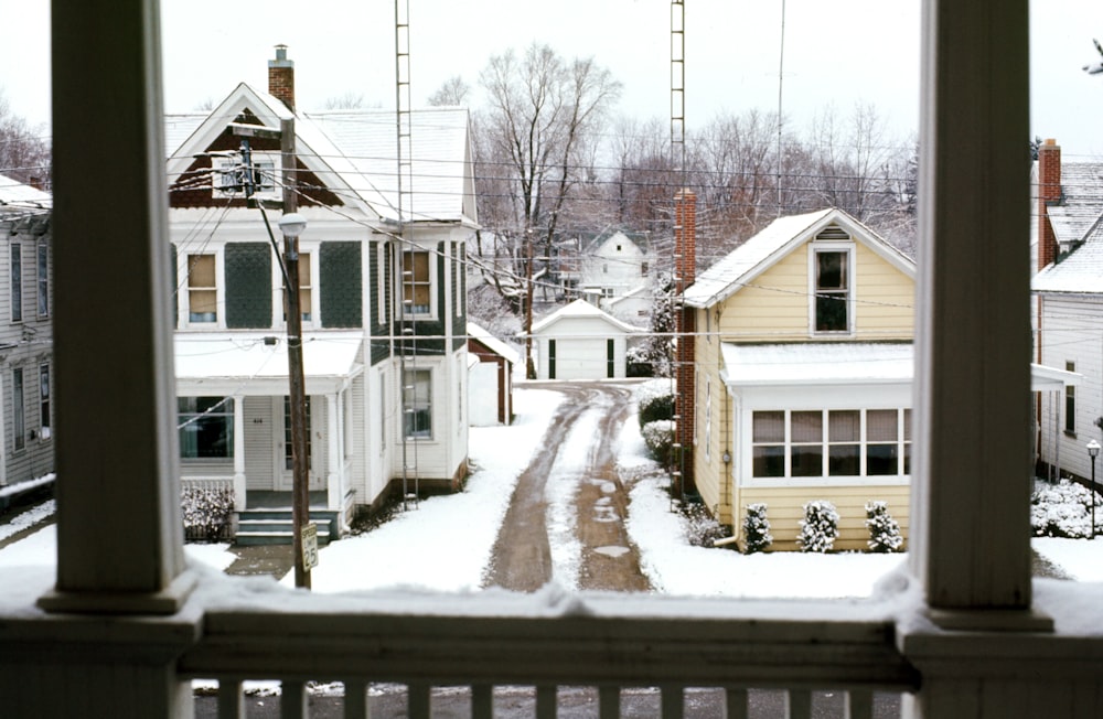 white and brown wooden house covered with snow during daytime