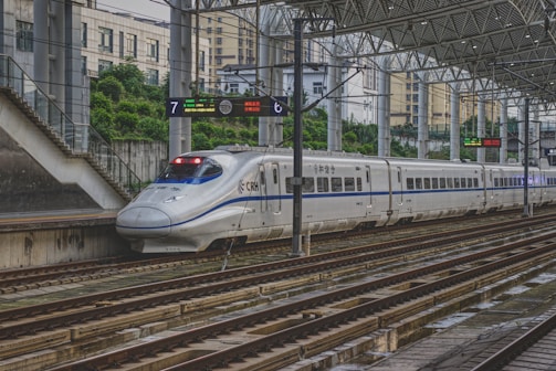 white train on rail way during daytime