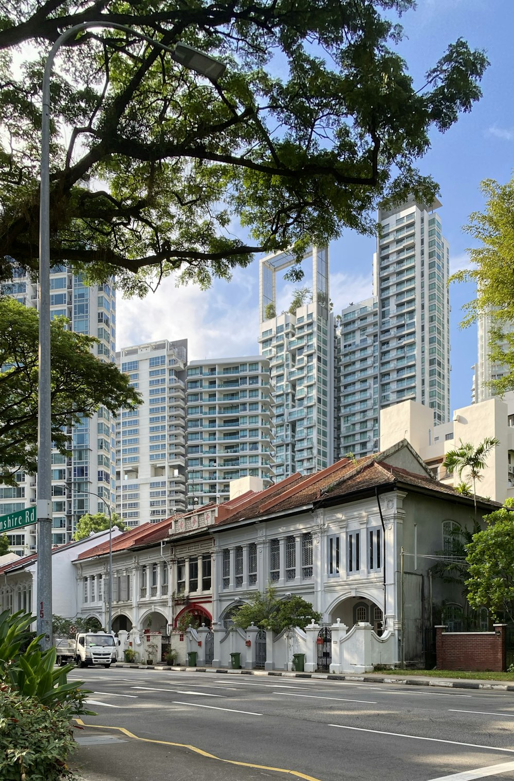 white and brown concrete building near green trees during daytime