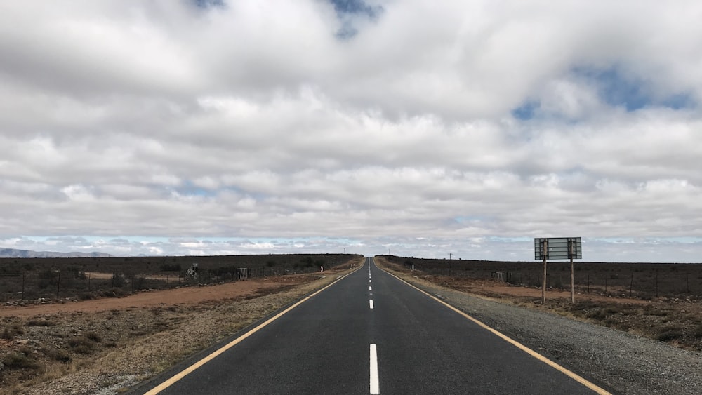 gray asphalt road under gray cloudy sky during daytime