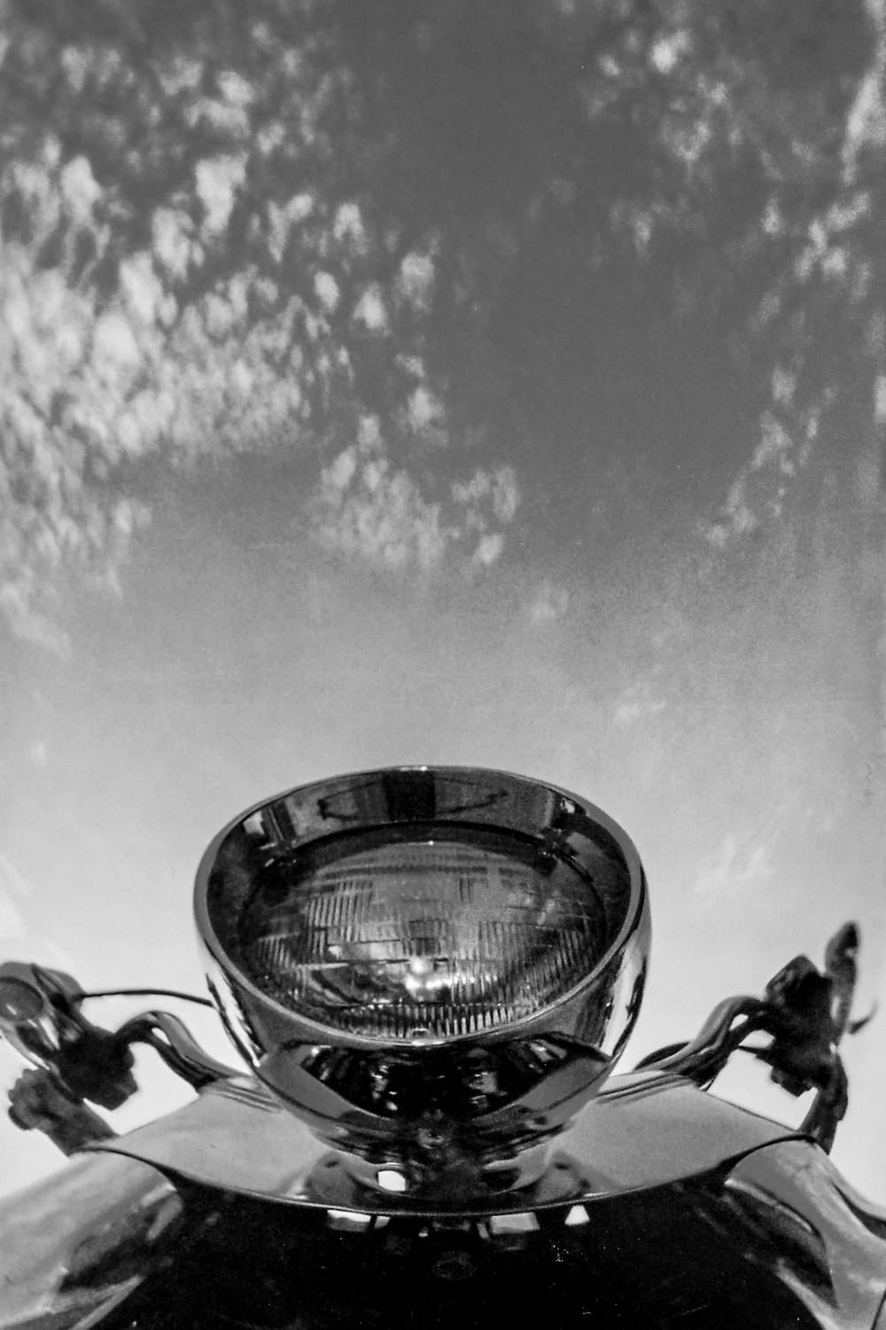grayscale photo of motorcycle with light