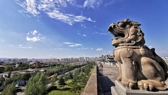 Traditional Lingnan-style stone carvings displayed against a backdrop of Hong Kong’s skyline.