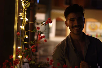 A candid photo of Gilson and Daniely smiling warmly under soft natural light, surrounded by delicate beige and blue decorations.