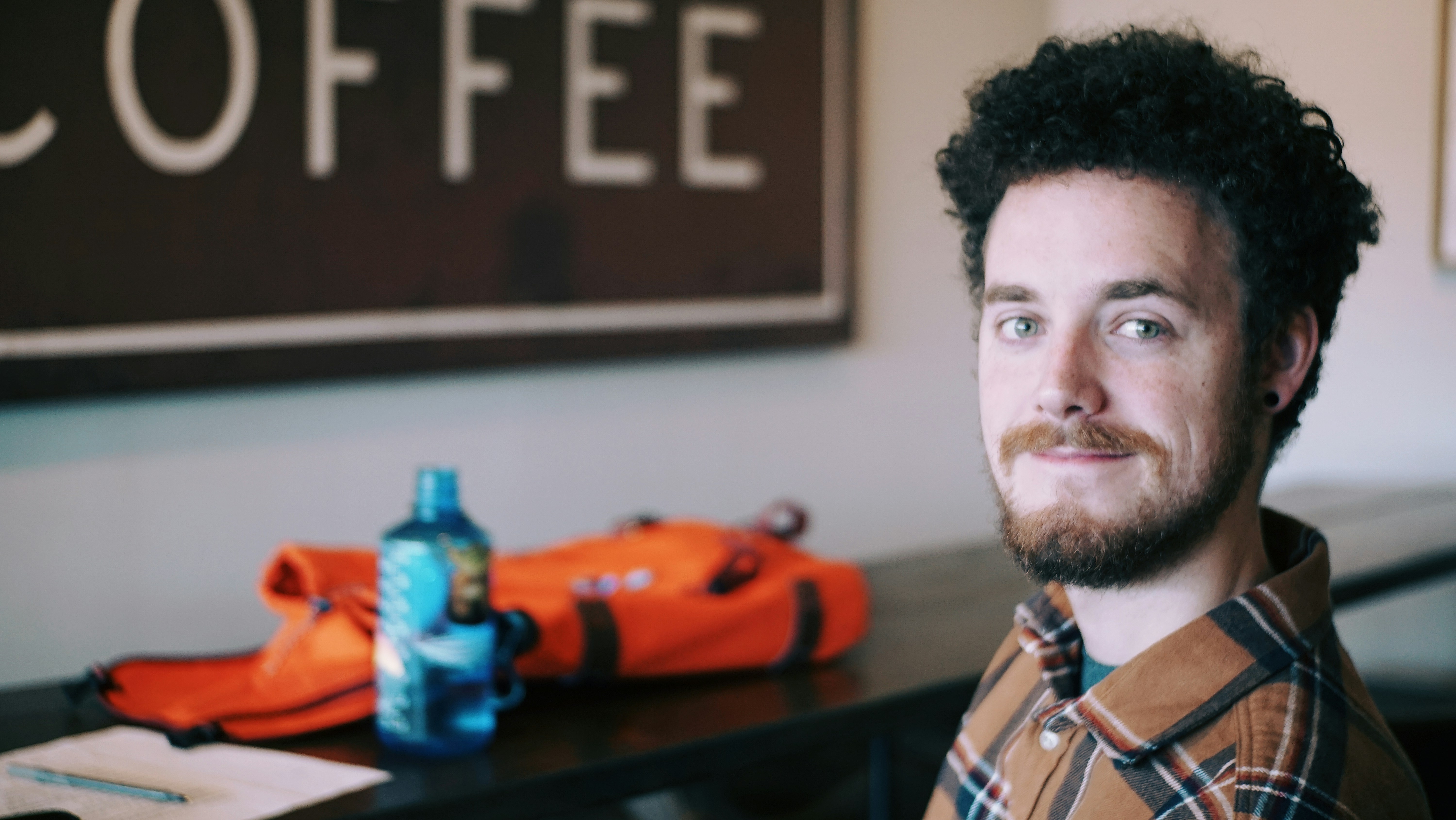 man in blue white and red plaid shirt