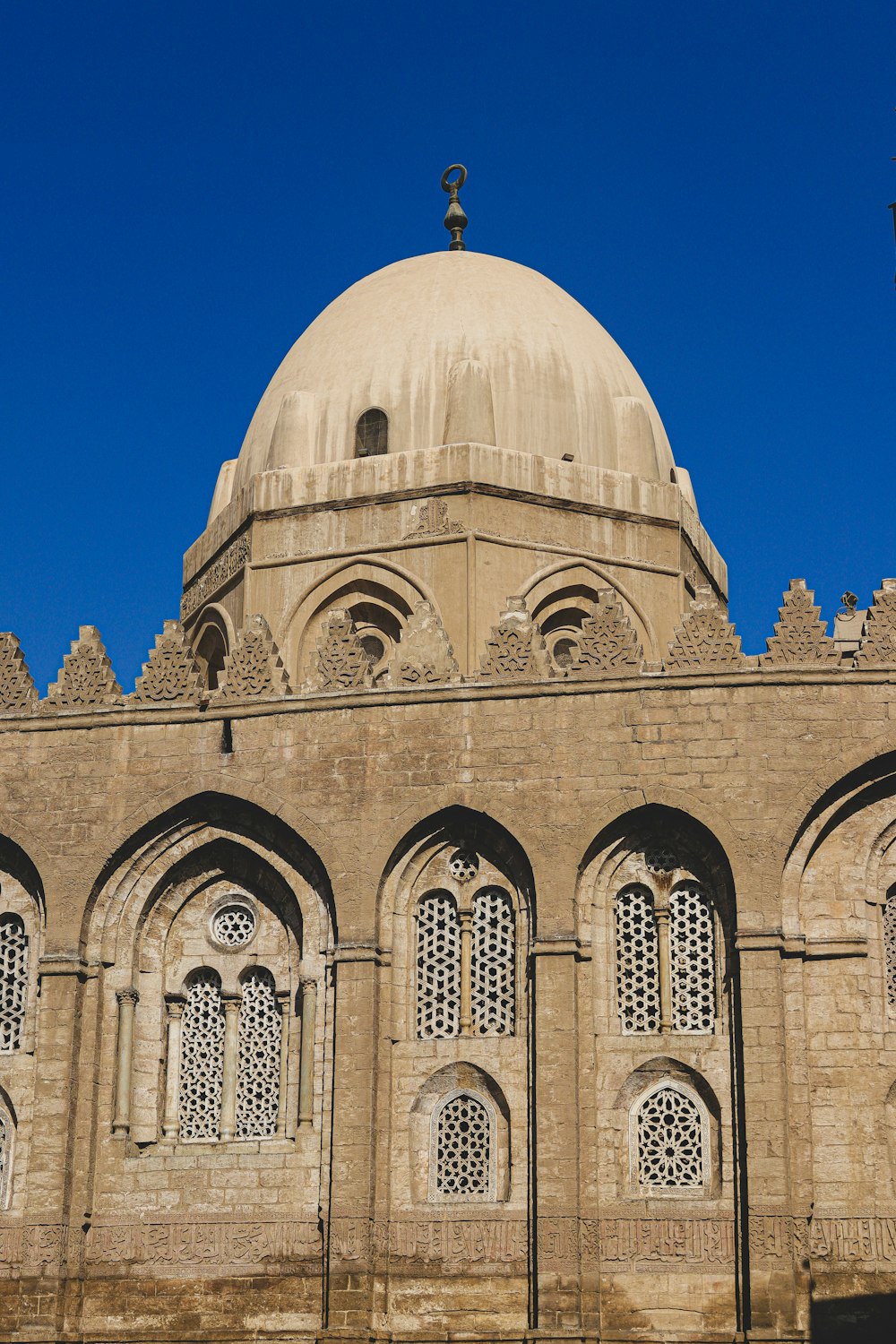 brown concrete dome building under blue sky during daytime