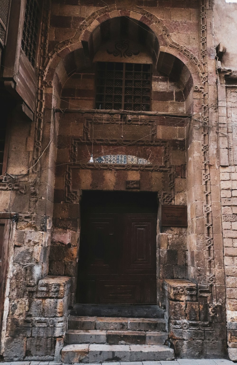 brown wooden door on brown concrete building