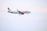 A commercial airplane in flight against a pale sky, featuring the logo and branding of Viva Aerobus on its fuselage and tail. The aircraft has red engines and markings, with visible landing gear extended.
