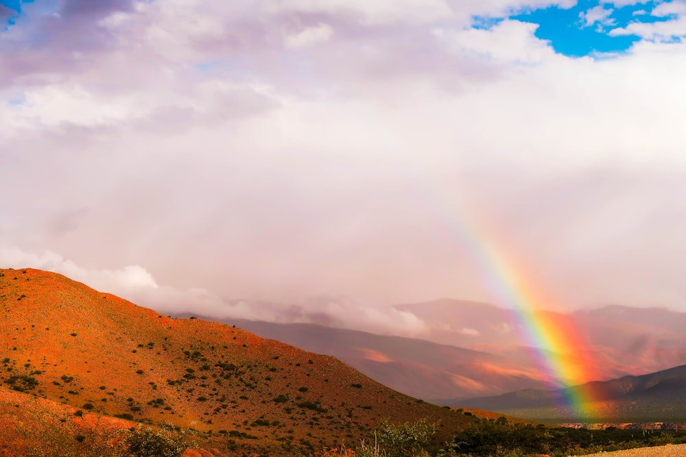 brown mountain under white clouds during daytime