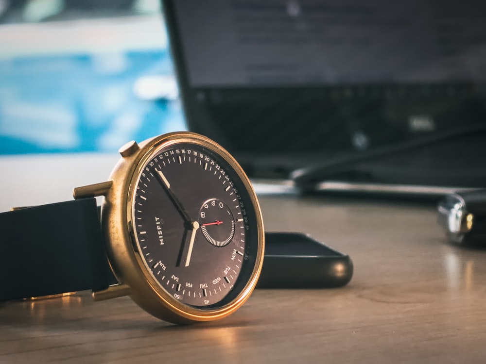 gold and black analog watch