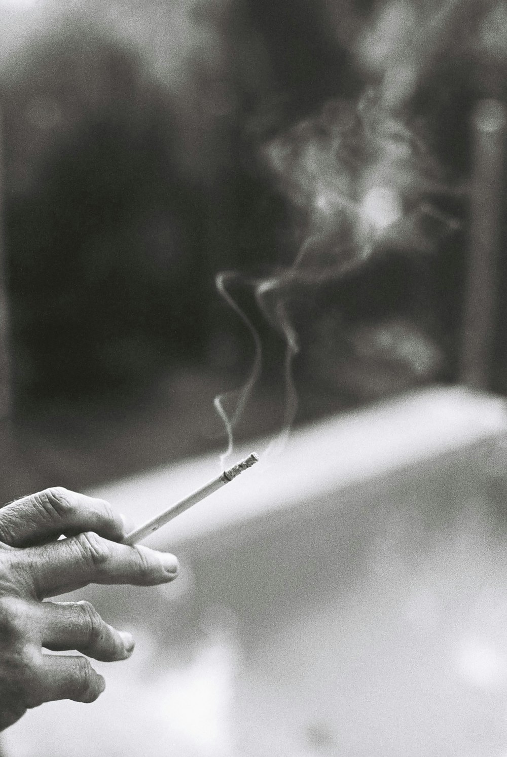 person holding white cigarette stick