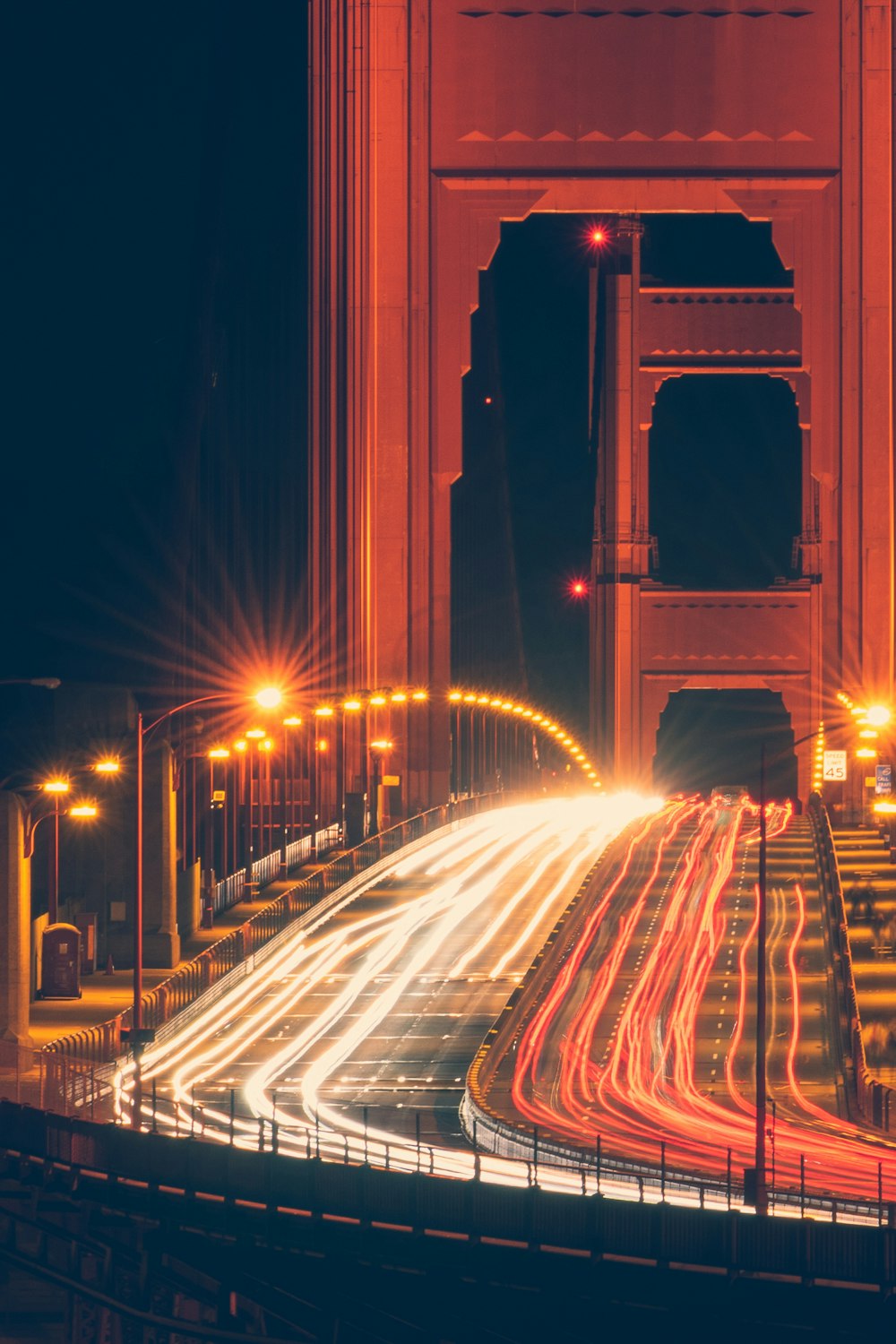 cars on bridge during night time