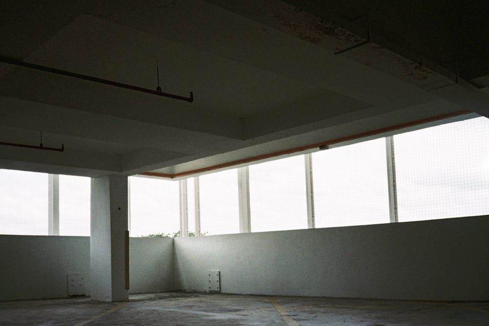 white concrete wall with glass window