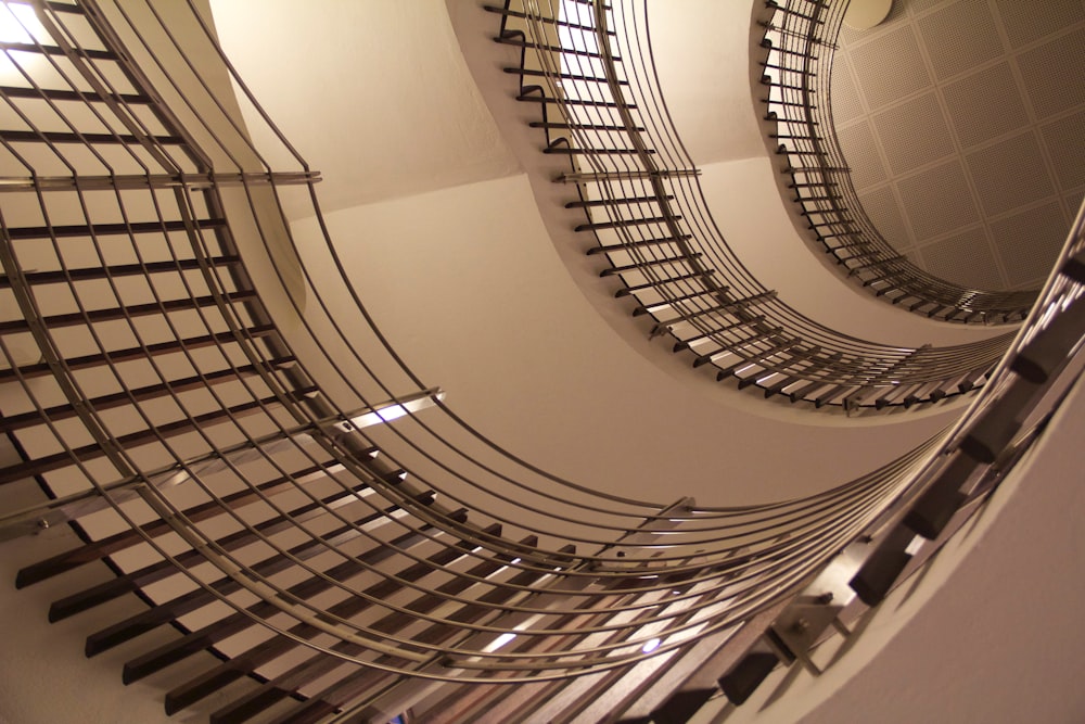 brown spiral staircase with brown metal railings