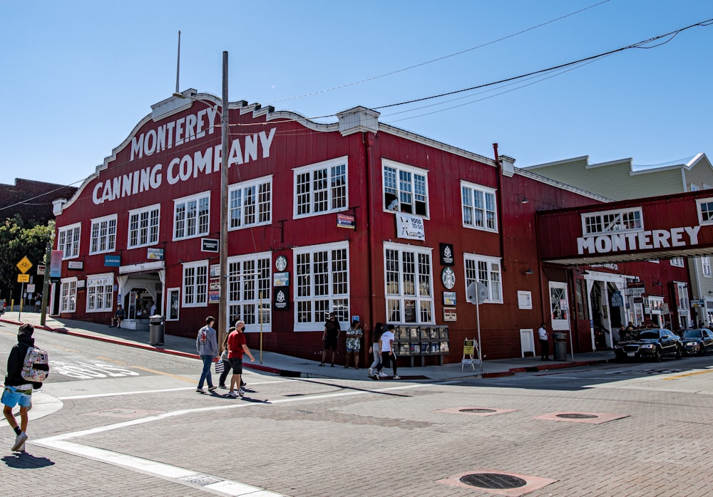 people walking near red concrete building during daytime