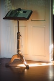 An open Quran resting on a wooden lectern with a soft glow.